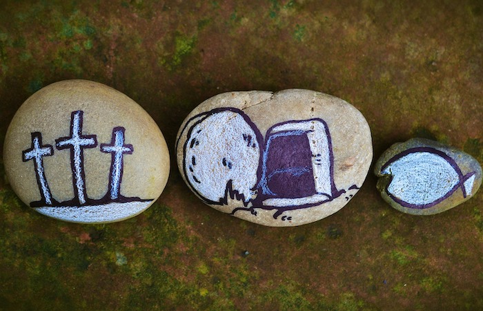 Pebbles painted with images of crosses, empty tomb and icthus fish